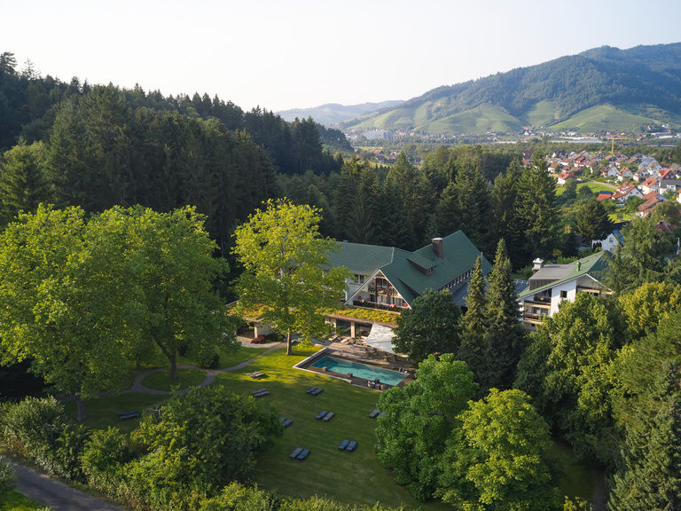 Eine Luftaufnahme des Wellnesshotels zeigt die idyllische Landschaft um das Gebäude.